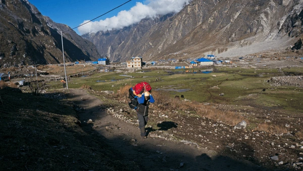 guide porter carrying goods in langtang trek